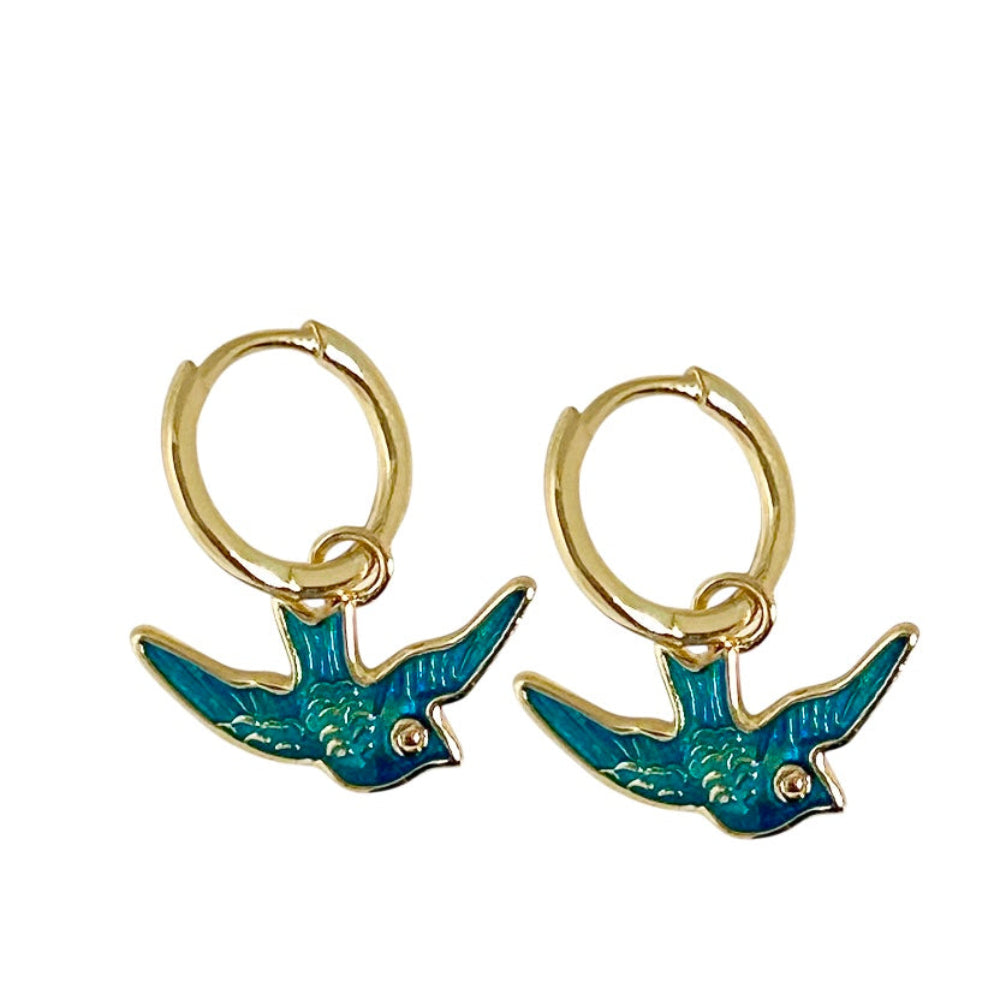 Gold hoop earrings with blue bird charms on a white background